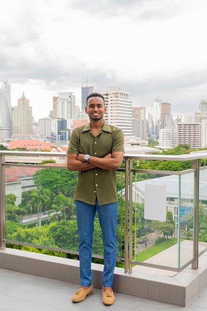 Portrait of handsome young black man outdoors in city