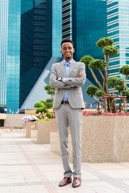 Portrait of handsome young black man outdoors in city