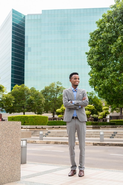 Portrait of handsome young black man outdoors in city