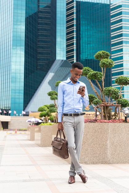 Portrait of handsome young black man outdoors in city