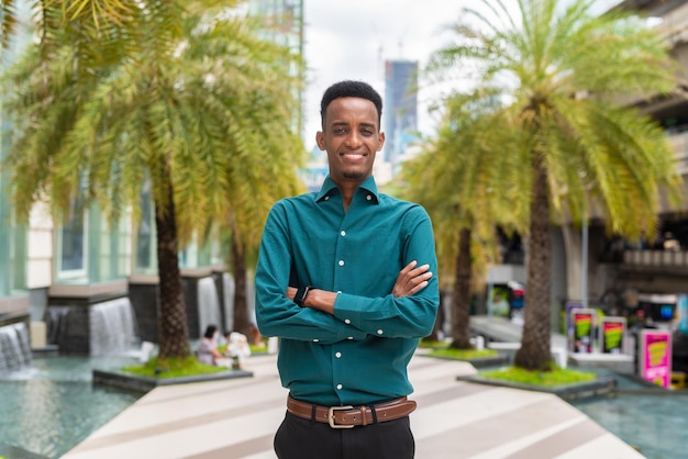 Portrait of handsome young black man outdoors in city