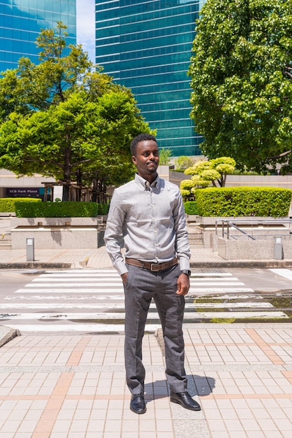 Portrait of handsome young black man outdoors in city