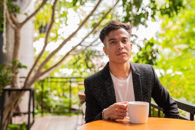 Portrait of handsome young businessman at coffee shop