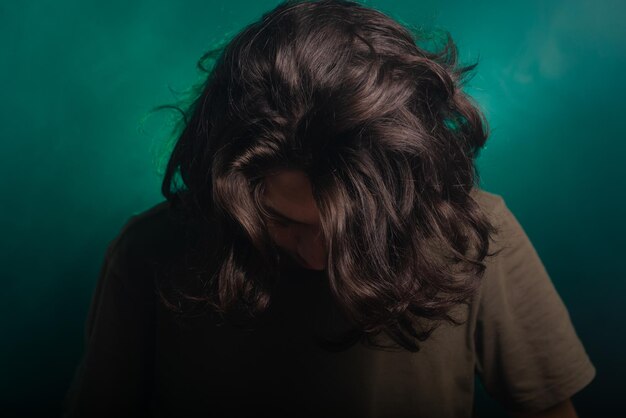 Portrait of handsome young man gesturing head in studio