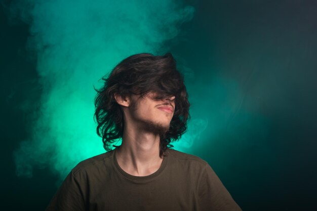 Portrait of handsome young man gesturing head in studio