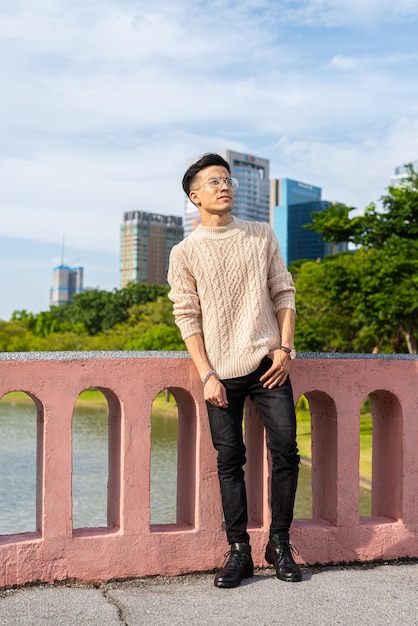 Portrait of handsome young man in park during summer