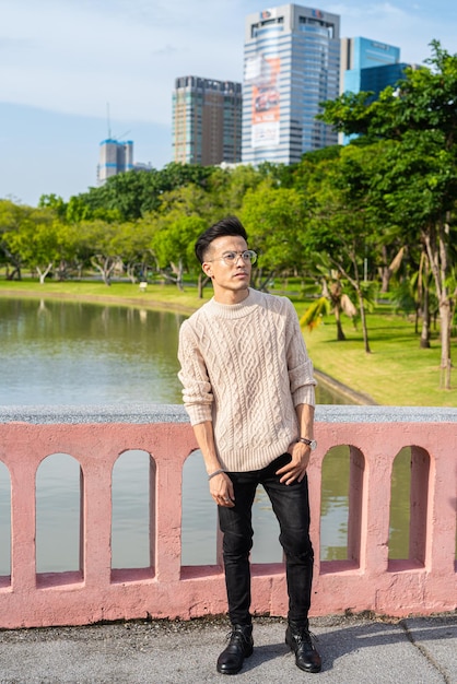 Portrait of handsome young man in park during summer