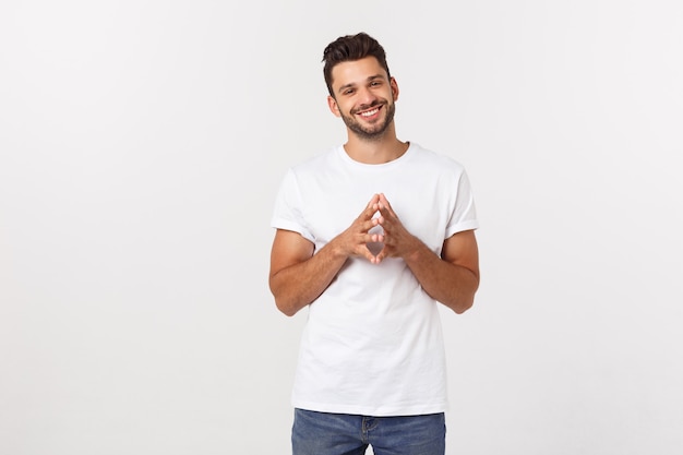 Portrait of a handsome young man smiling against yellow wall