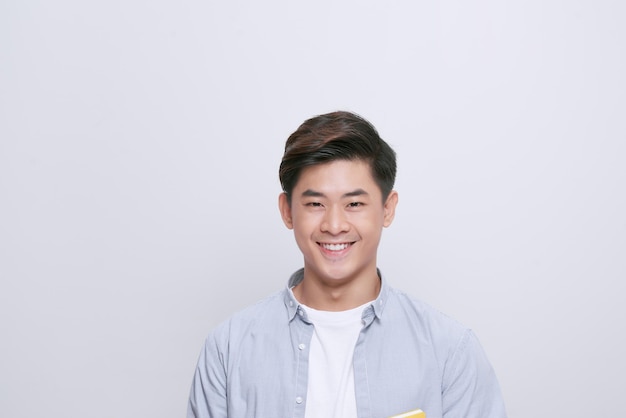 Portrait of handsome young man with beaming smile on white background