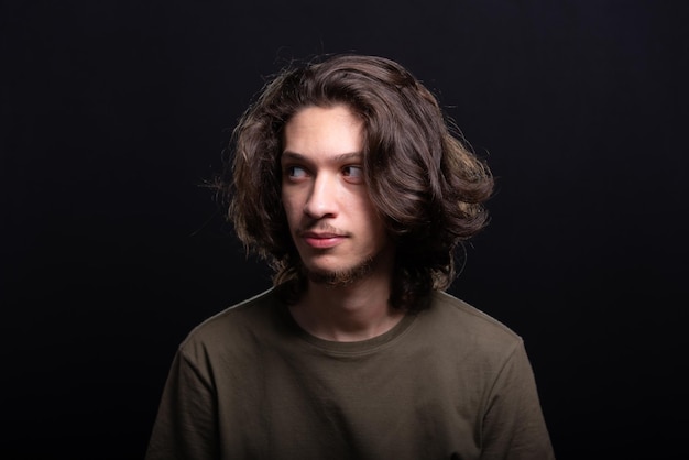 Photo portrait of handsome young man with long hair and brown eyes posing for photo