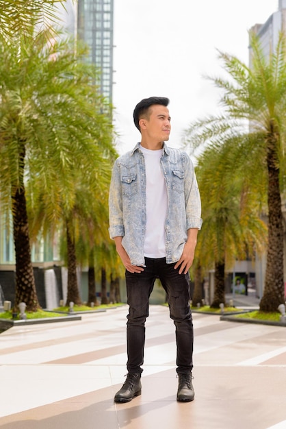 Portrait of handsome young stylish man outdoors in city