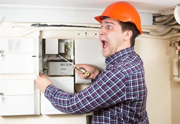 Portrait of handyman being hit by high voltage while repairing transformer at home