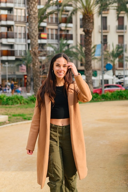 Portrait of a happiness young woman looking at the camera on the street