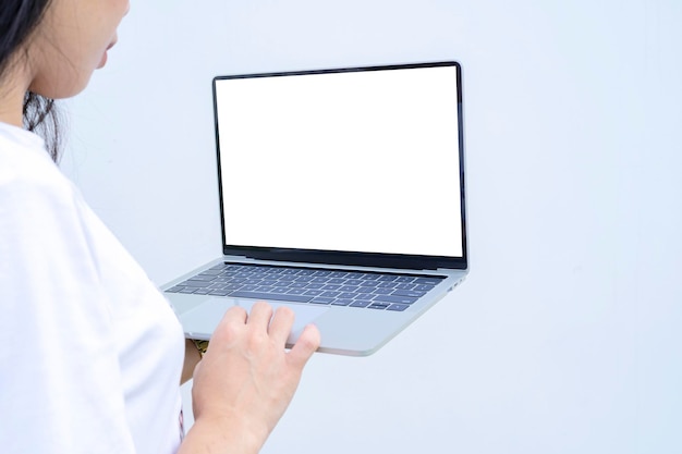 Portrait of a happy asian businesswoman holding laptop computer and hands typing on a laptop keyboard with isolated screen isolated over white background