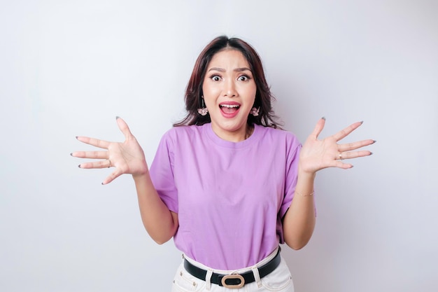 A portrait of a happy Asian woman wearing a lilac purple tshirt isolated by white background