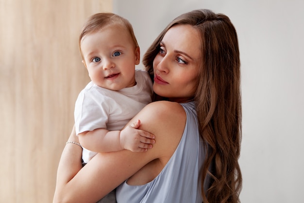 portrait Happy beautiful caucasian family Attractive Mother loves her son small child blue eyes