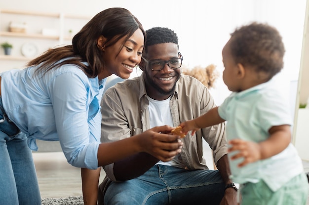 Portrait of happy black family smiling playing at home