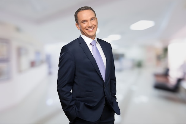 Portrait of happy businessman on background