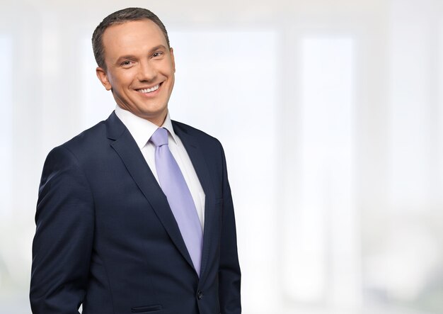 Portrait of happy businessman on background