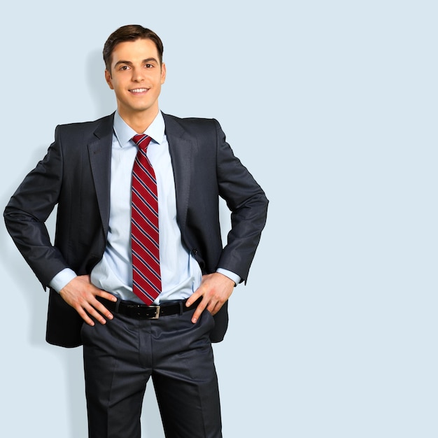 Portrait of happy businessman on background