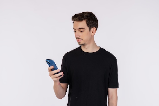 Portrait of a happy businessman using smartphone over white background