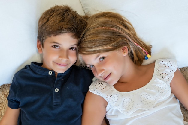 Portrait of a happy Caucasian boy and girl looking at the camera