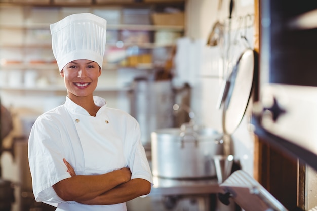 Portrait of happy chef standing with arms crossed