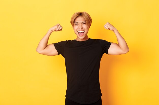 Portrait of happy and confident asian blond guy