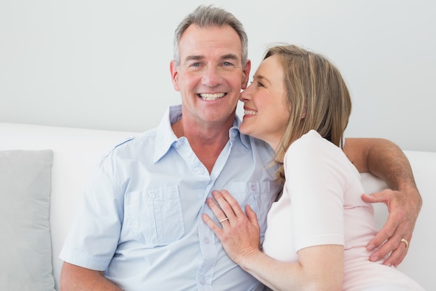 Portrait of a happy couple embracing in living room