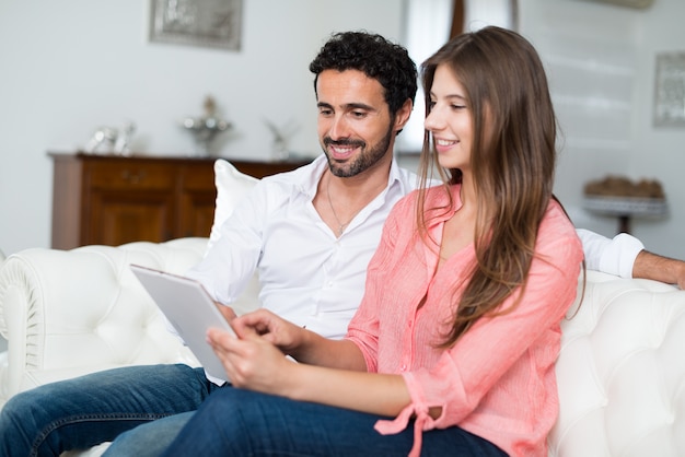 Portrait of an happy couple using a tablet. 