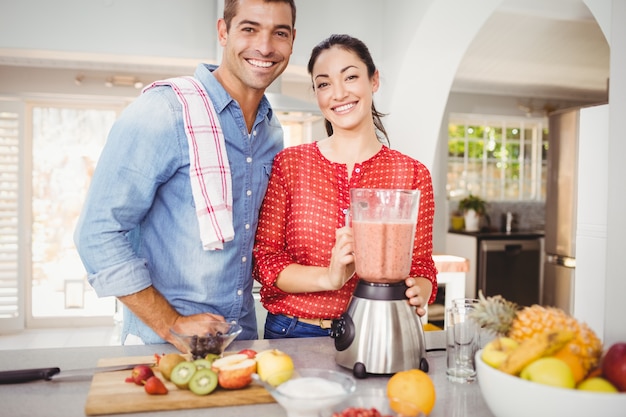 Portrait of happy couple with fruit juice