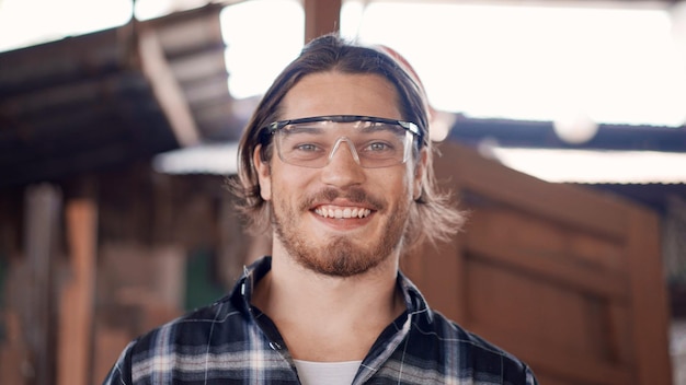 Portrait of happy craftsman owner looking smile to camera at the carpentry workshop