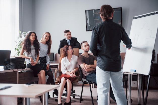 Portrait of a happy creative team of people talking in the office at the meeting.