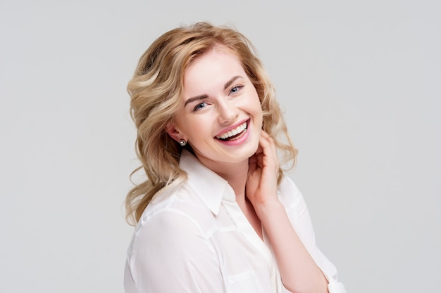 Portrait of happy curly girl in white shirt