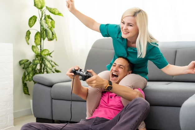 Portrait of happy excited family playing video games