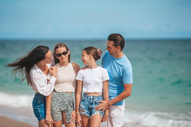 Portrait of happy family on the beach during summer vacation