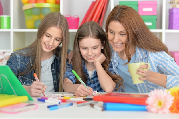 Portrait of happy family doing homework together