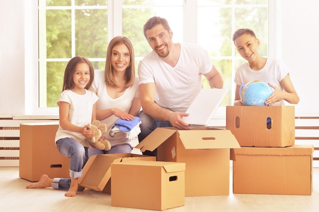 Portrait of happy family in new home