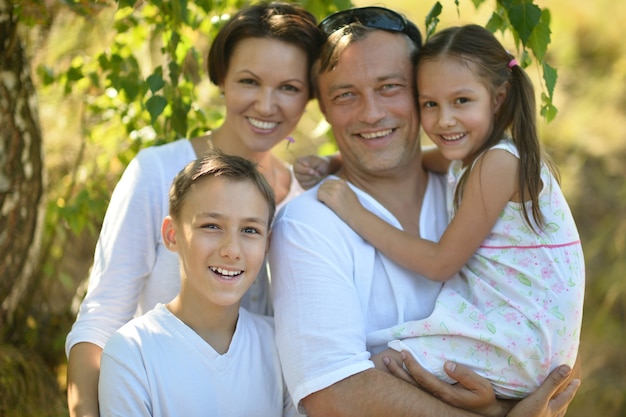 Portrait of a happy family resting in  summer park