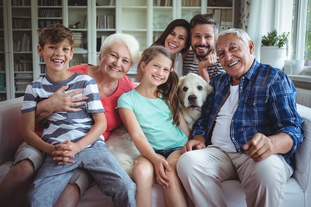 Portrait of happy  family sitting on sofa in living room