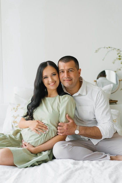 Portrait of a happy family waiting for a new family member a child