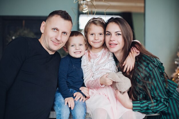 Portrait of a happy family with children relaxing in Christmas atmosphere