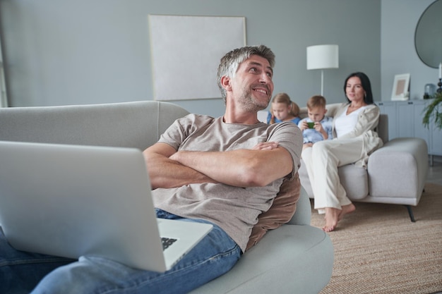 Portrait of happy father against the background of her happy family