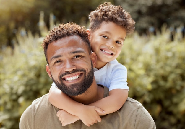 Portrait happy father and boy smile in garden fun vacation and break in summer happiness together Black man and child smile love and hug outdoor bonding free time on a sunny day in the park