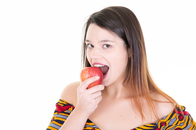 Portrait of happy girl holding eating red apple