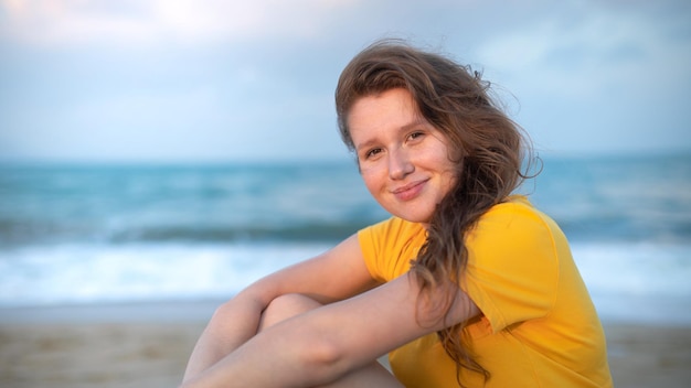 Portrait of happy girl young carefree woman enjoying summer vacation on sea walking on beach sand smiling and having fun in tropical country relaxing on nature Summertime happiness concept