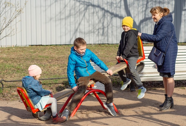 Portrait of a happy grandmother with her grandchildren outdoors connection of generations concept