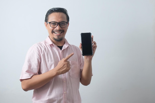 Portrait of happy guy pointing phone screen