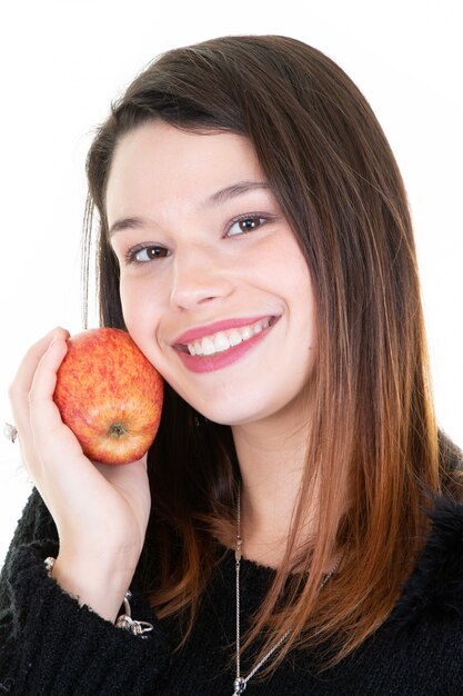 Portrait of happy healthy young woman hugging with red apple