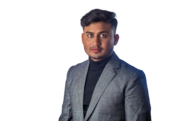 Portrait of Happy Indian young man businessman wearing a blazer on grey background posing satisfied successful male in formal suit